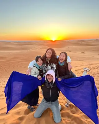 a group of girls posing for a picture in the desert at Luxury Merzouga stars camp in Merzouga