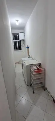 a white room with a table and a refrigerator at Cozy apartment in Fès