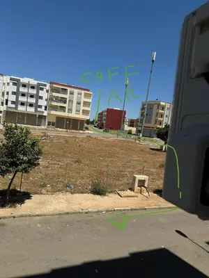 a view of a city with buildings and a bench at Home Louah Apartment Retreat in Oulad Tayeb