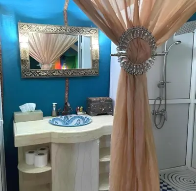 a bathroom with a sink and a mirror at Desert Berber Luxury Camp in Merzouga