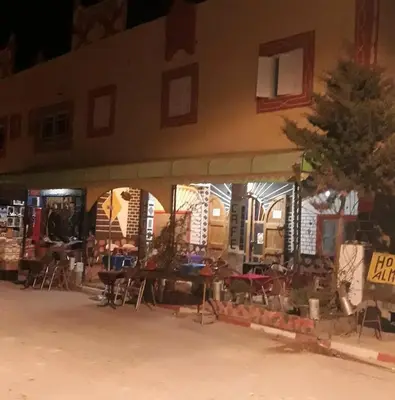 a building with tables and chairs in front of it at almou auberge imilchil in Imilchil