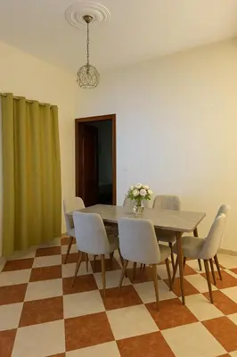 a dining room with a table and chairs at Residence Kawtar Meknès Marjane 2 in Meknès