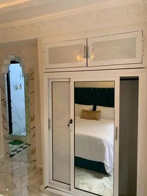 a bedroom with a cupboard with a bed in it at Appartement bel kayed in Fès