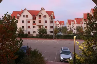 a car parked in a parking lot in front of a building at Appartement juste pour les familles in Ifrane