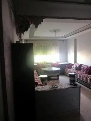 a living room with a couch and a table at Kinan in Taza