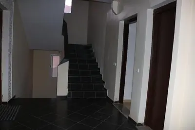 a staircase in a house with black tile floors at Les jardins d'Ifrane in Ifrane