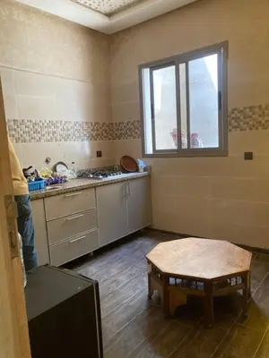 a room with a kitchen with a table and a window at Ourika in Aghbalou