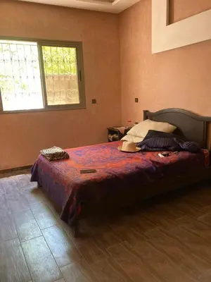a bedroom with a large bed in a room at Ourika in Aghbalou