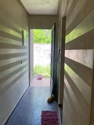 a hallway with a door open to a room with a doorway at Ourika in Ourika