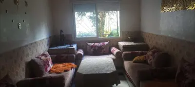 a living room with couches and a large window at Appartement La Joie in Oulad Akkou
