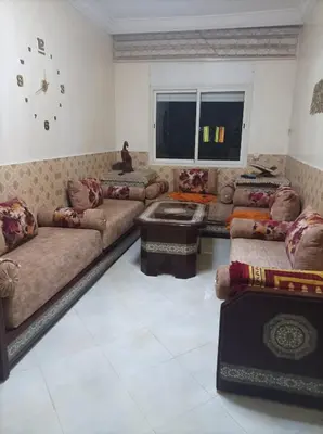 a large living room with couches and a window at Appartement La Joie in Oulad Akkou