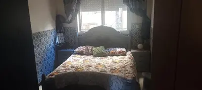 a bedroom with a bed and a window at Appartement La Joie in Oulad Akkou
