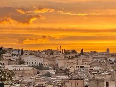 a view of a city at sunset at Dar Drouj a Special 14th Century Familyhouse Riad in Fès