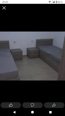 a television screen showing a bedroom with two beds at Ikamat nakhil in Oulad Akkou