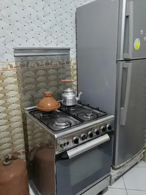 a kitchen with a stove with a tea pot on it at Ikamat nakhil in Oulad Akkou
