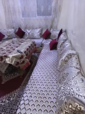 a large bed with pillows on it in a room at Ikamat nakhil in Oulad Akkou