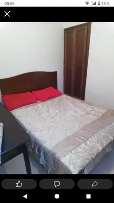 a bedroom with a bed with red pillows on it at Ikamat nakhil in Oulad Akkou