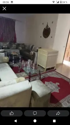 a living room with a couch and a table at Ikamat nakhil in Oulad Akkou