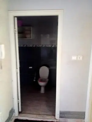 a bathroom with a toilet in a dark room at Malak in Taza