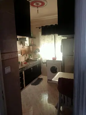a kitchen with a refrigerator and a washing machine at Malak in Taza