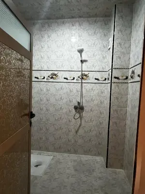 a bathroom with a shower with a glass door at Hay nahda dakhla in Oulad Akkou