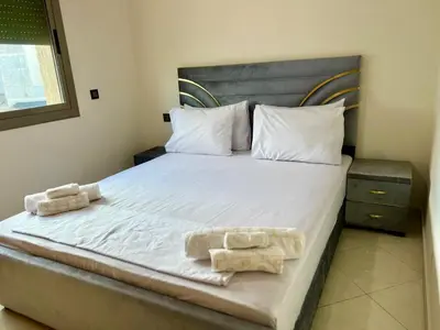 a bedroom with a bed with two towels on it at Residence Noor - Central Apartments Fes in Fès