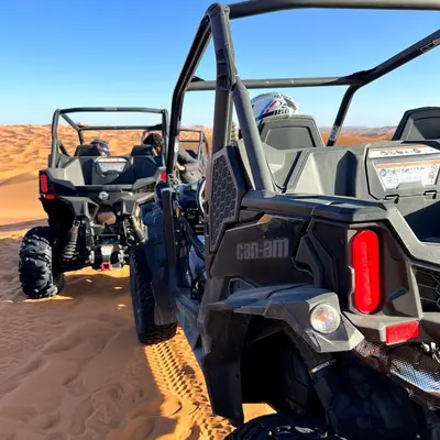 two atvs parked in the sand in the desert at Desert Bloom Luxury Camp in Merzouga