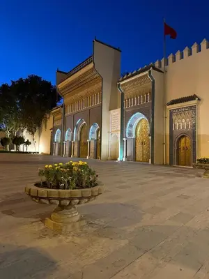 a large building with a fountain in front of it at Dar Kenza in Fès