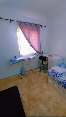 a room with a desk and a bed and a window at شقةبالقرب من مطار مراكش المنارة الدولي in Oulad Akkou