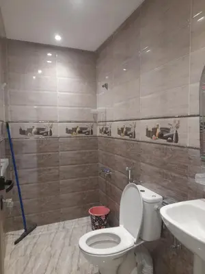 a bathroom with a toilet and a sink at diki ksar sghir in Oulad Akkou