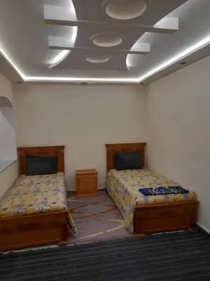 a room with two beds and a ceiling at diki ksar sghir in Oulad Akkou
