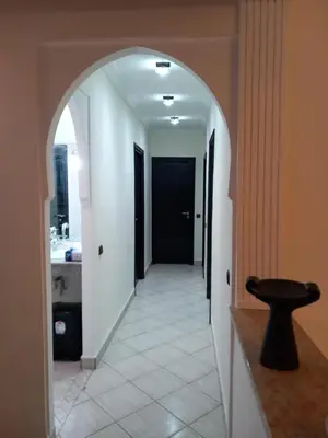 an archway leading into a hallway with a bathroom at Al boustane1 in Oulad Akkou