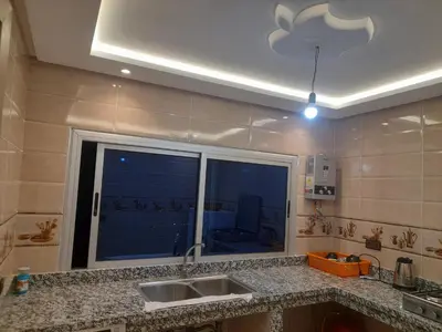 a kitchen with a sink and a large window at diki in Oulad Akkou