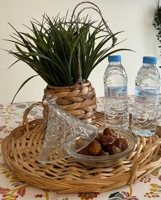 a basket with water bottles and a bowl of nuts at Aéroport Service navette vers logement cosy in Oulad Akkou