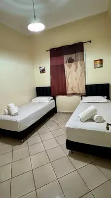 a room with two beds in a room at Aéroport Service navette vers logement cosy in Oulad Akkou