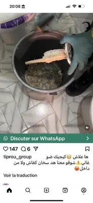 a person is cooking food in a pan at Aéroport Service navette vers logement cosy in Oulad Akkou