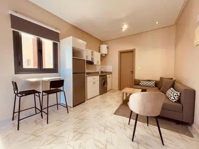 a living room with a couch and a table at Relax Family 06 - Cozy Studio in City Center in Ouarzazate