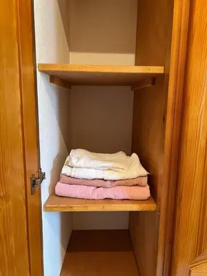 a closet with some folded towels on a shelf at Apartment for rent by the day in Oulad Akkou