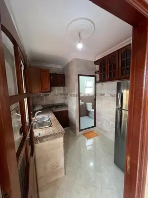 a small kitchen with a sink and a refrigerator at Apartment for rent by the day in Oulad Akkou