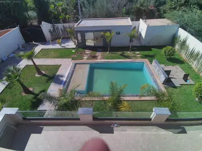 an aerial view of a backyard with a swimming pool at Villa GHMAT in Aghmat