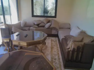 a living room with a couch and a coffee table at Villa GHMAT in Aghmat