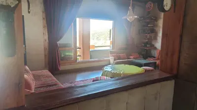 a mirror reflection of a living room with a window at Villa de rêve in Bine el Ouidane