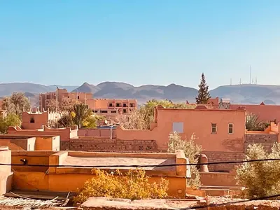 a view of a city with buildings and mountains at Relax Family 01 - Cozy Entire Apartement in City Center in Ouarzazate