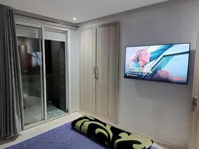 a living room with a flat screen tv on a wall at Appartement hay mohammadi GH26 in Oulad Akkou