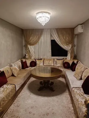 a living room with a couch and a table at Appartement hay mohammadi GH26 in Oulad Akkou