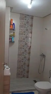 a bathroom with a shower and a toilet in it at شقة مريحه in Oulad Akkou