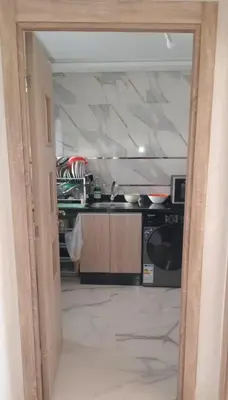 a kitchen with a sink and a microwave at شقة مريحه in Oulad Akkou