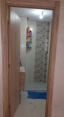a bathroom with a shower with a glass door at شقة مريحه in Oulad Akkou