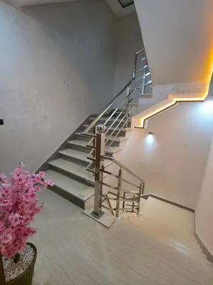 a spiral staircase in a building with pink flowers at appartement luxueux khenifra 1 in Khenifra