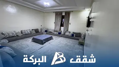 a living room with a couch and a tv at Appartements Al Baraka in Oulad Akkou